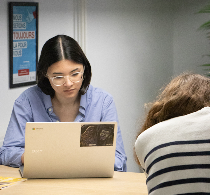 femme sur son ordi de face et une autre dame de dos